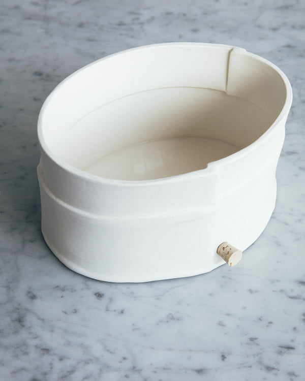 Porcelain Planter -  As an alternative to the traditional plant saucer this pot features a small hole and waxed cork for drainage. / Jardinière en porcelaine - Comme solution de rechange à la cuvette d’arrosage traditionnelle, ce pot est muni d’un petit trou et d’un bouchon de liège ciré servant au drainage. 